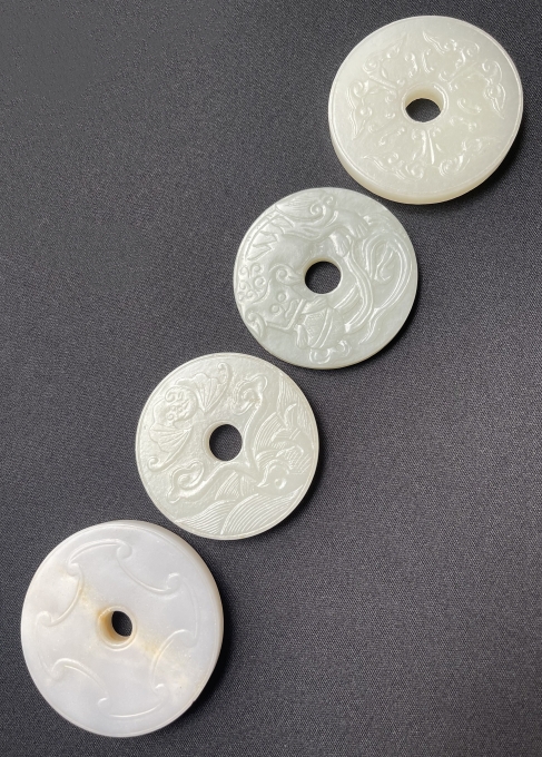 GROUP OF FOUR ANTIQUE CHINESE LATE QING DYNASTY CARVED JADE DISCS